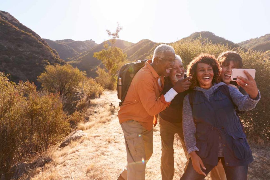 group of seniors hiking in mountains