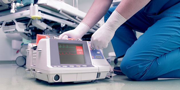 doctor handles cardiac machine