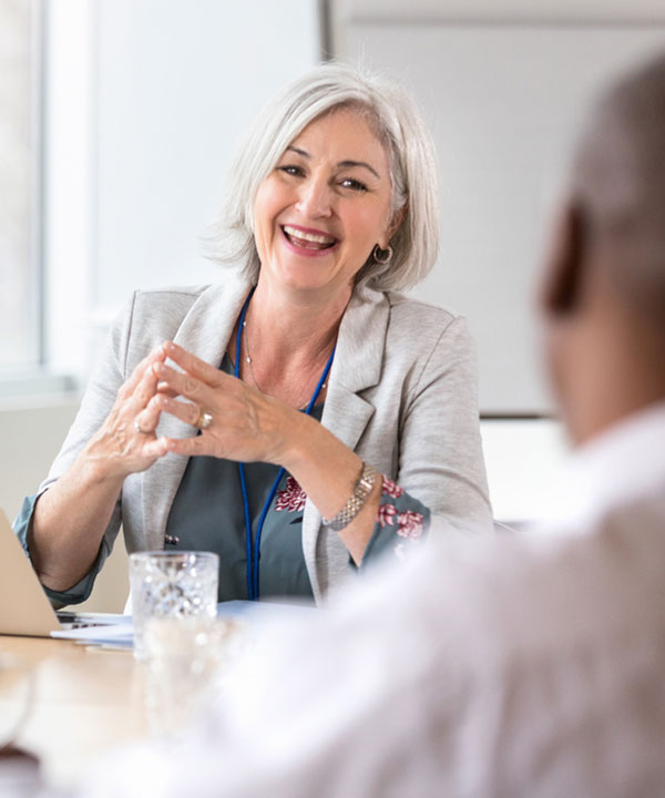 two people discuss at a meeting