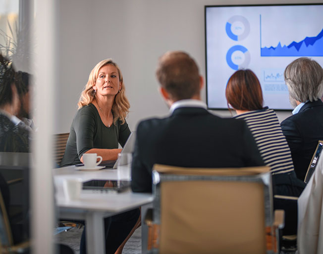 several colleagues meet to discuss graphs