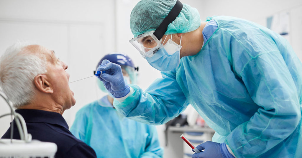 medical worker administers covid test to patient