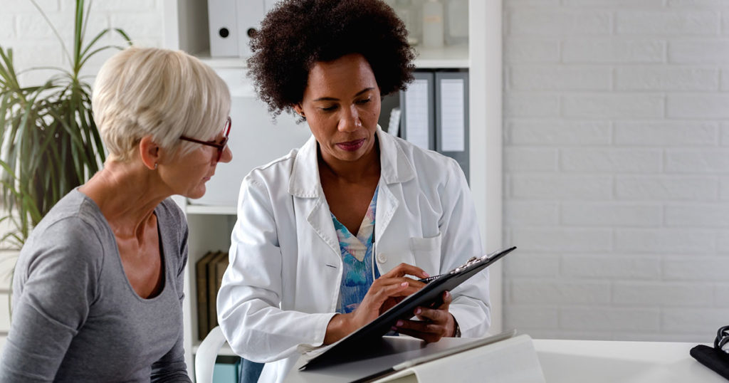 doctor consulting with senior patient