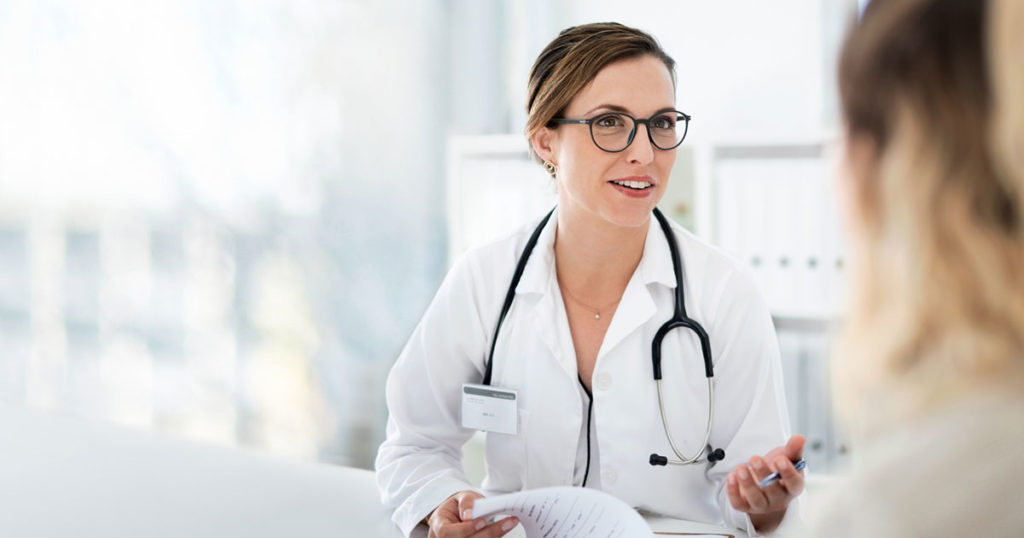 female doctor speaks to female patient