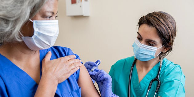 medical worker vaccinates patient
