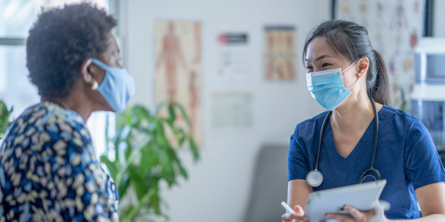 doctor consults with patient