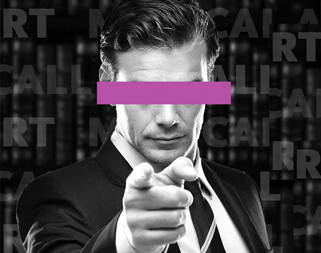 a man in a suit pointing at the viewer with a purple bar obscuring his eyes