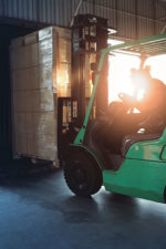 a factory worker loads boxes