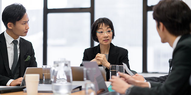 three business people in a meeting