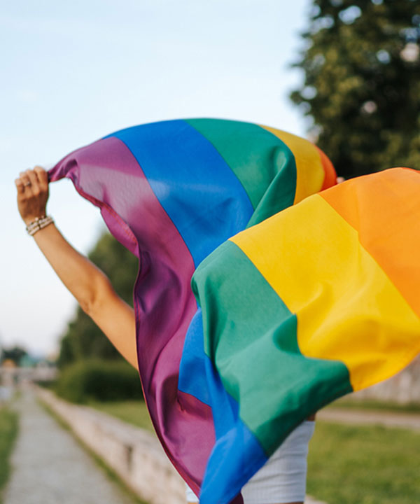 person running with pride flag