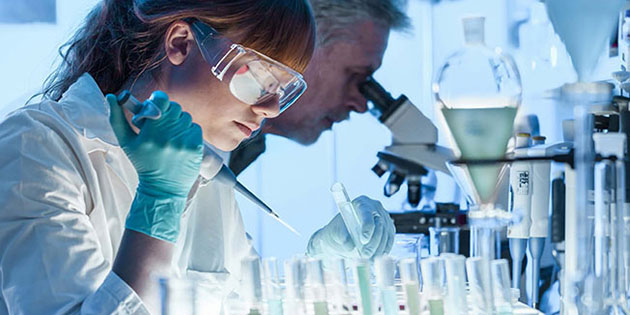 researchers examine vials