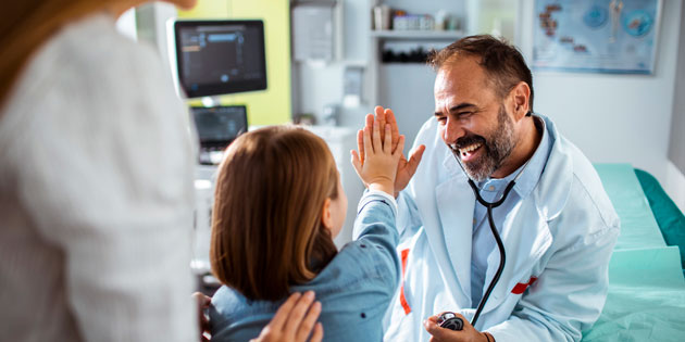 doctor high fives child patient