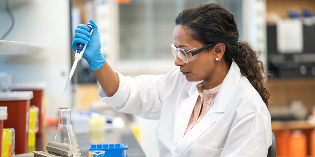 scientist pipetting in laboratory