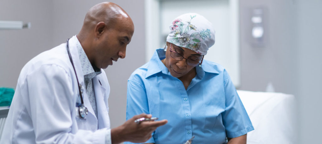 doctor speaks with cancer patient