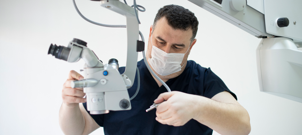 technician repairs operating microscope