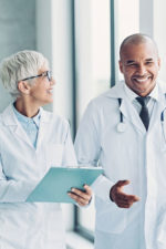 two doctors smiling and walking