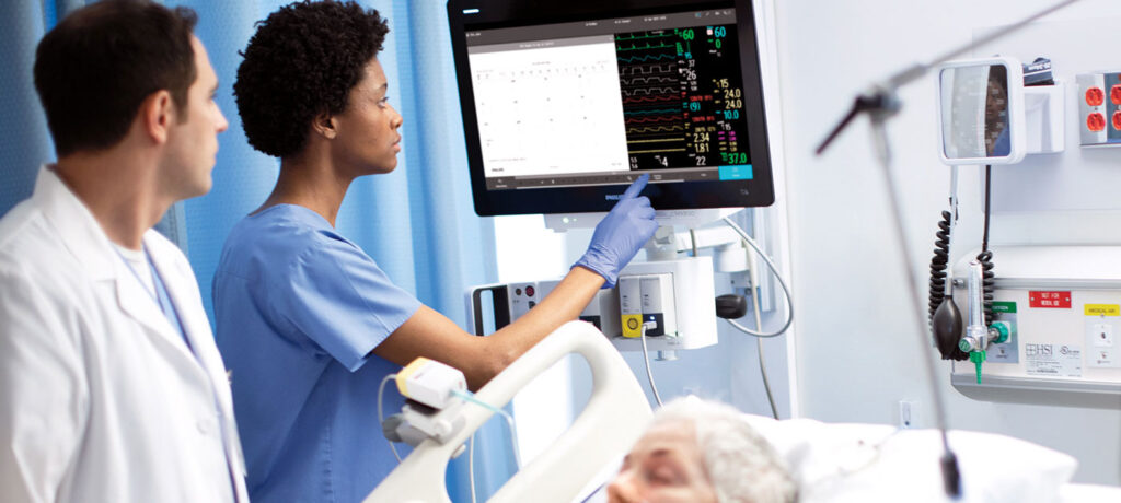 doctor and RN monitor a patient's vitals