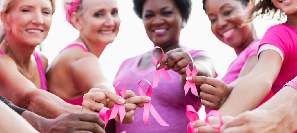 women hold pink ribbons
