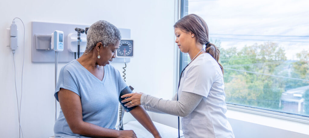 nurse takes patient's blood pressure