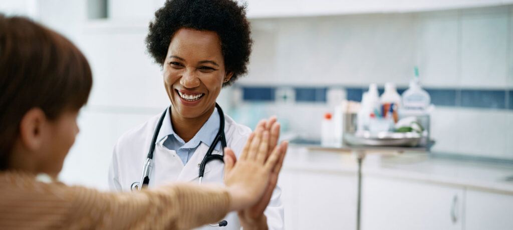 doctor high-fives young patient