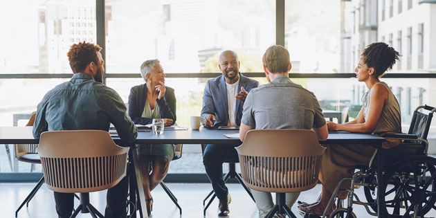 several people discuss around a conference table