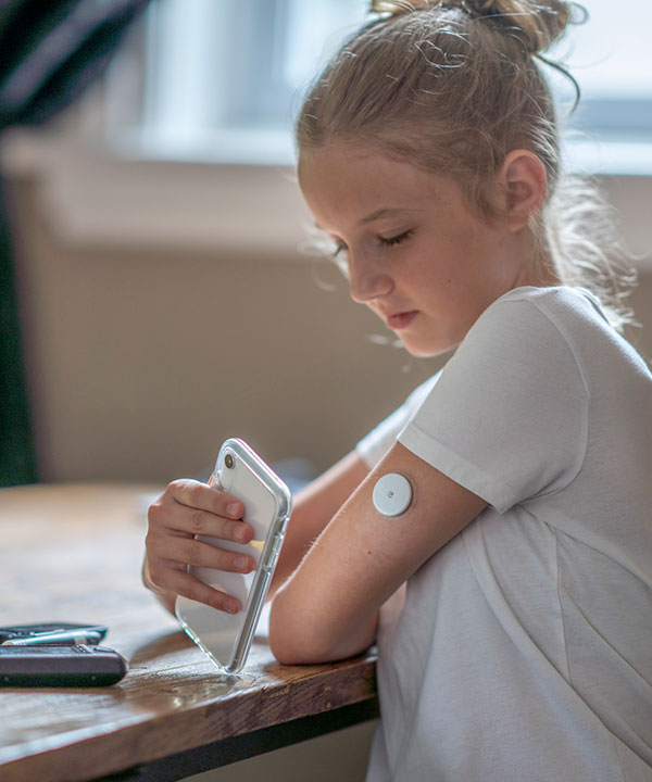 child monitoring blood glucose with devices