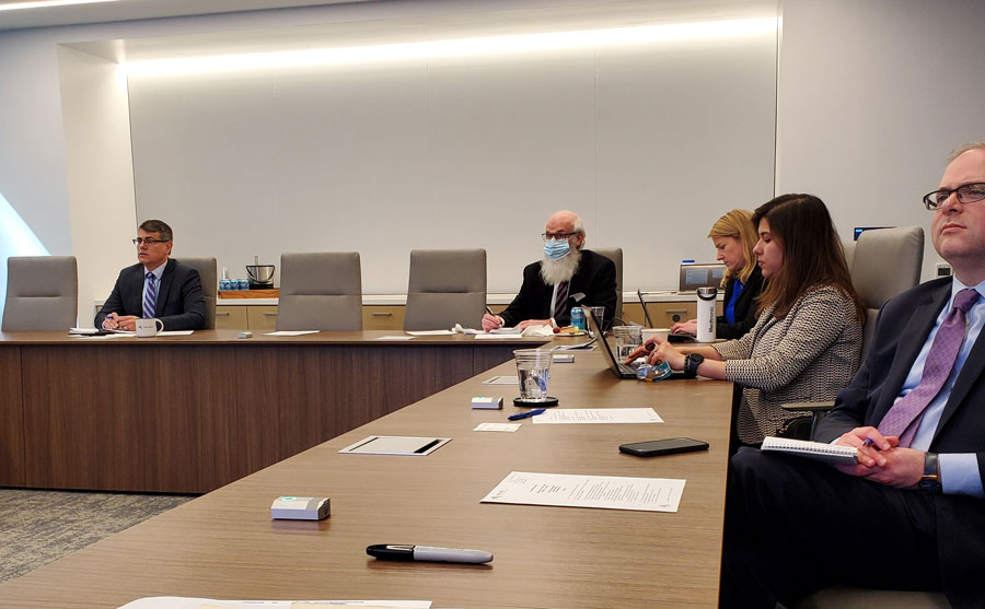 five people seated in a conference room