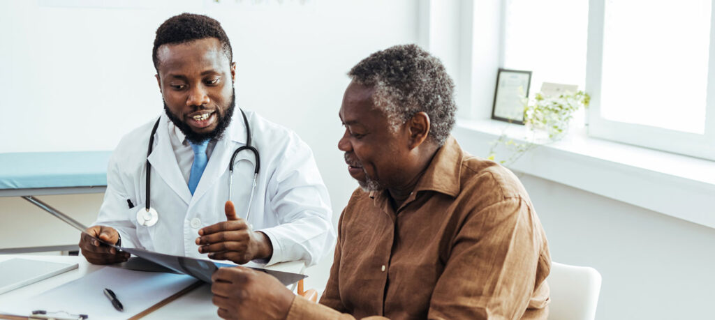 doctor speaks with senior patient