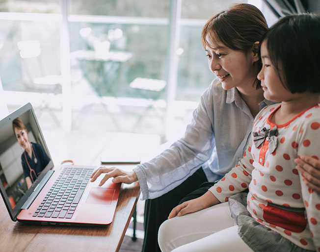 Asian mother and child consult doctor on virtual visit