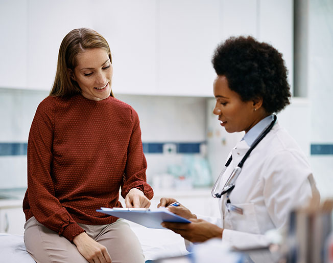 doctor and patient discussing clipboard