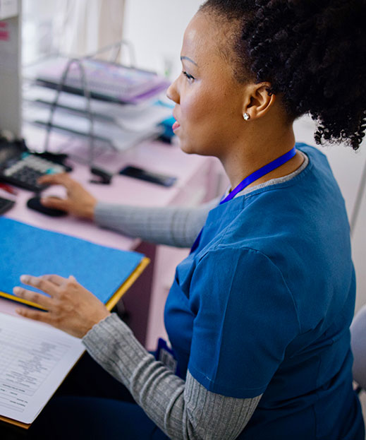 medical professional working at computer