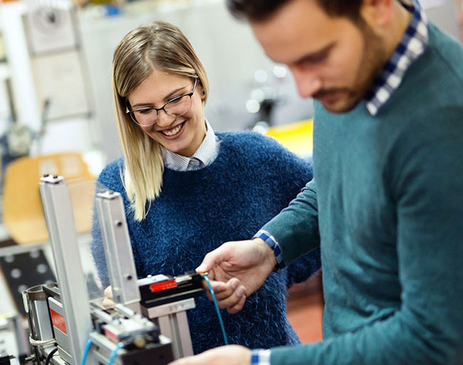 two young scientists examining devices