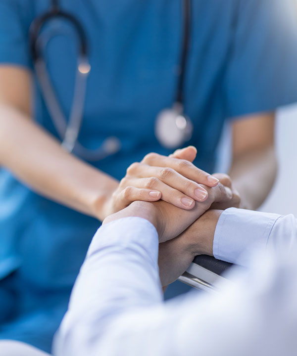 nurse holding both patient's hands