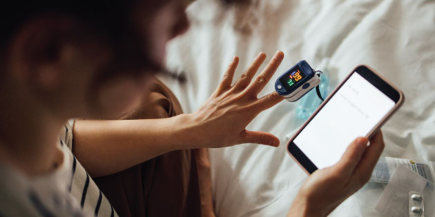 Woman checking her heart rate at home.