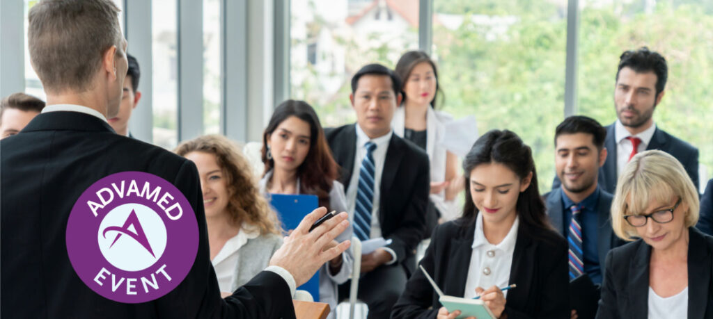 Man giving a presentation at a podium in front of an audience