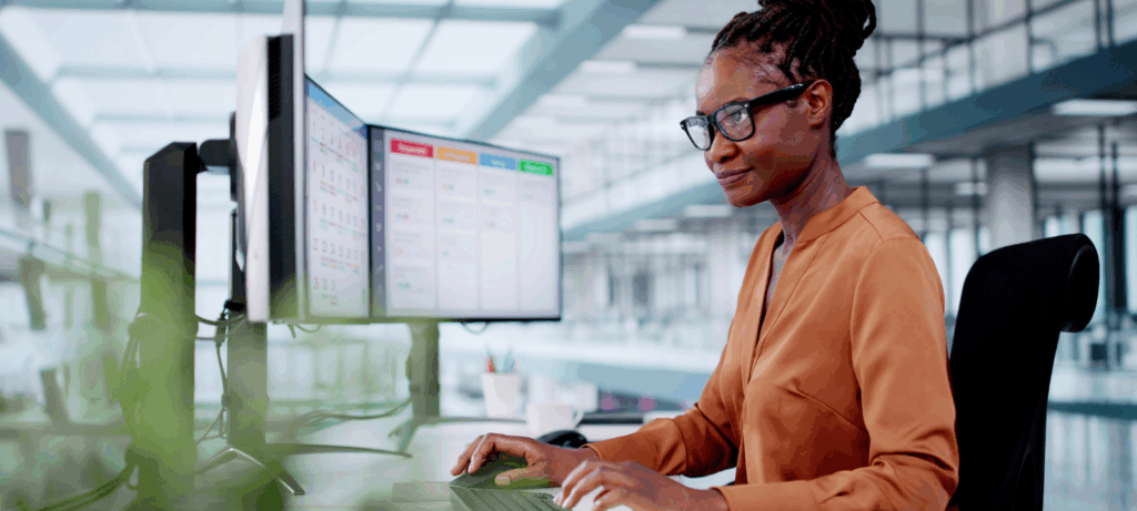 Woman at a computer looking at Business Schedule Calendar And Agenda Gantt Report