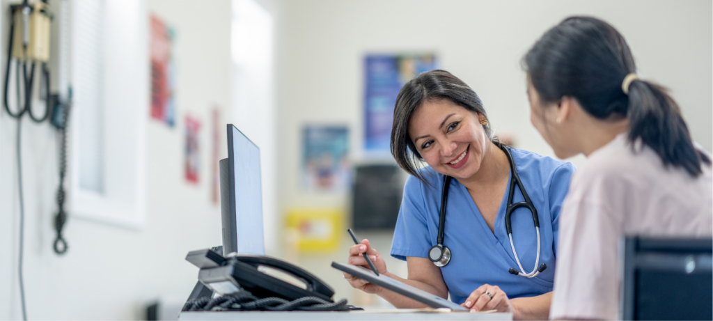 young woman sitting next to her doctor